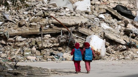 Syrian girls, carrying school bags provided by UNICEF, al-Shaar neighborhood, Aleppo. 2015. IZEIN ALRIFAI-AFP.GImages